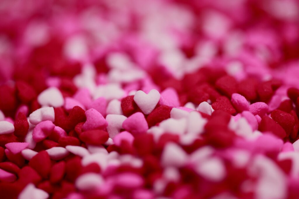 Close-up of pink, red, and white heart-shaped sprinkles.